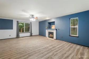 The living room. The newer laminate floors extend through the living room and up to the second story.