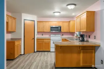 The kitchen is nicely sized for cooking with lots of cabinet and counter space, plus great extra storage in the large pantry.