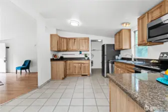 Utility room and back door is straight ahead through kitchen. That is where washer/dryer would be placed and water heater is there as well.  The home is all-electric.