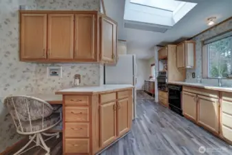 Skylights above along with the large kitchen window over the sink bring in joyful natural light.