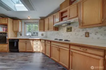 Beautiful cabinetry and expansive counters surround the kitchen.