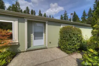 Take a walk along the pathway surrounded by established plantings leading to the traditional front door of the home.