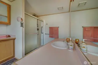 The new walk-in shower boasts an overhead rain style shower head with adjustable hand spray and the convenience of a removable bench seat.