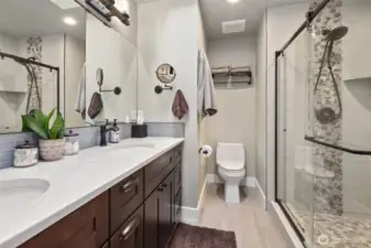 Primary bathroom is gorgeous, with heated floors, large shower, and dual vanity sink.