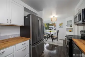 The kitchen has new cabinets, butcher block countertops and new appliances.