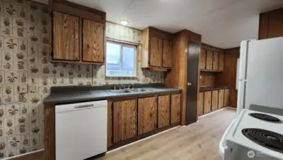 Large open kitchen with lots of cupboards.