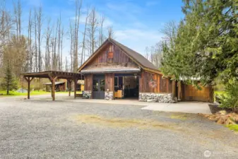 Shop with 4-bay carport and large retractable awning.