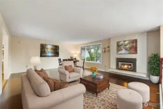 Virtually staged upstairs main living area with cozy gas fireplace