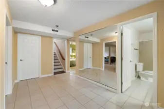 Extra storage behind door to left of stairs. Large mirrored wall and open space for yoga, workouts or maybe....dancing!