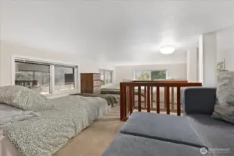 Loft with couch and three beds.