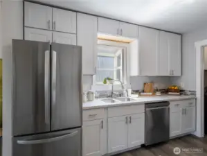 The white cabinets goes all the way up to the ceiling for maximum storage and ease of maintenance.