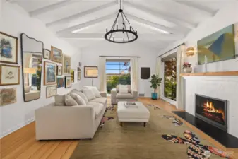 Vaulted beamed ceilings in the living room welcome you home.