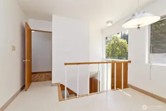 The back set of stairs to the lower level. This is in the extra eating space off of the kitchen. There's a back door here leading to the fully-fenced back yard.