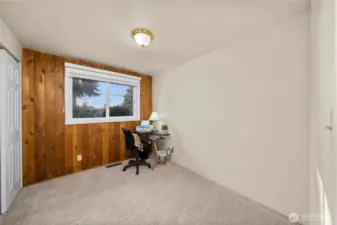 Third bedroom w/ large closet and wood panel accent wall.