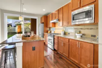 Classic and dialed in. A comfortable kitchen that checks all the boxes. The glass floors exit to the covered back patio, yard with garden space, detached garage and extra parking space off wide alley.