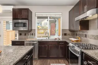 The garage door beyond the window opens inside the fenced yard.