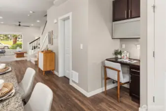 A small desk area near the kitchen.  Half-bath to the left of it.