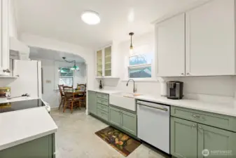 Stunning remodeled kitchen featuring custom wood cabinetry with pull-out storage, a farmhouse sink, and top-of-the-line appliances