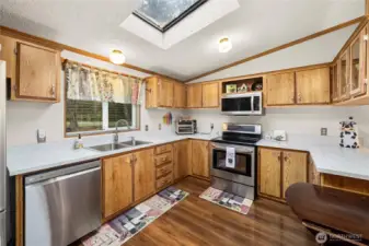 Well-designed kitchen offers ample counter space, storage, and natural light for comfortable, efficient cooking.