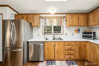 Bright kitchen features warm wood cabinetry, ample counter space, and stainless steel appliances for everyday ease.