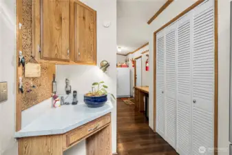 Built-in desk adds a functional workspace while maintaining a seamless flow between the kitchen and utility room.