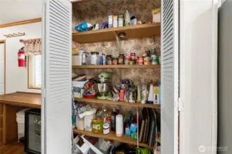 Convenient pantry space provides abundant shelving for organized, easy living.