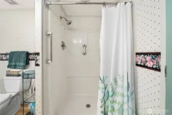 Primary bathroom also has a walk-in shower offers easy access and a clean, functional design for daily comfort.