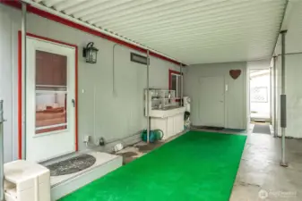 Gated carport area includes a sweet potting bench, offering a functional space for gardening and outdoor projects.