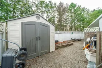 Detached storage shed provides a space for tools, hobbies, or seasonal items.