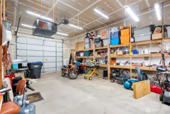 33' x 20' RV garage lined with storage shelving and its own washer and dryer