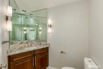 The main floor powder room has an infinity mirror.