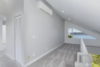 Looking from the top of the stairs to the second level through theoffice space to the view. There is a mini-split here and in the primary bedroom that provide cooling when needed.