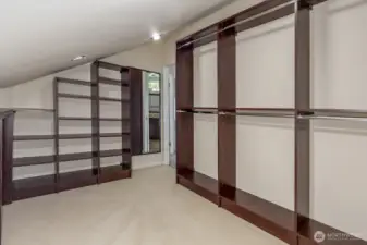 The walk in closet with custom built ins.