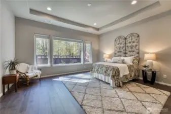 Primary suite located at the back of the home is spacious and bright with upgraded hard surface flooring.