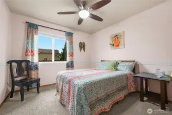 Bedroom #2 on main floor with new carpet and ceiling fan.