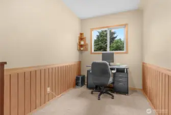 Hidden just above the garage and off the bonus room area is this wonderful office/den space with nice wood wainscoting.