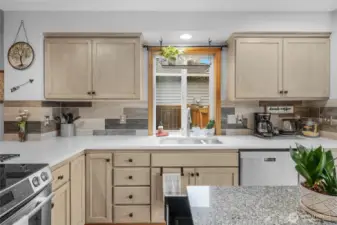 This kitchen's spacious design allows plenty of room for food preparation, plus there's no lack of storage. The large countertop makes this an excellent location for doing so. The ample natural light makes the area bright.  Hardwood floors lead out to large dining room area and all appliances included!