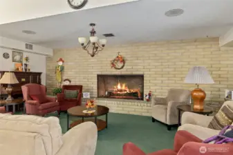 Clubhouse fire place meeting area, also has commercial kitchen, large dining area, recreational room and library area, plus outside entertaining and pool.