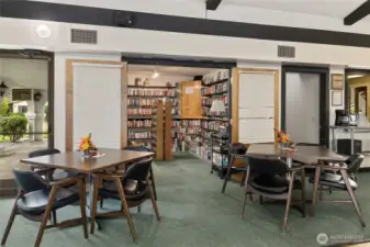 Library room showing part of the dining area and kitchen.