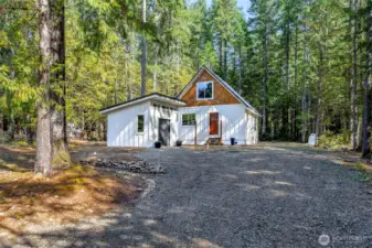 Outbuilding is 12' x 11' +/- with laundry hookup and storage.
