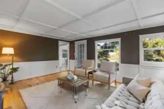 Living room is stuffed to the brim with beautiful millwork, and a stunning fireplace mantel, all ready for holiday stockings!