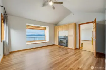 Huge Main-floor view primary suite w/ 5 pc. bath, fireplace & walk-in closet.