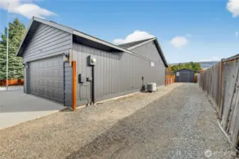 Graveled RV parking running the length of the house