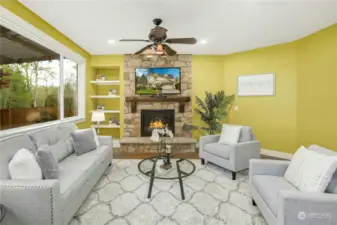 Open concept family room with gas fireplace and built-ins.