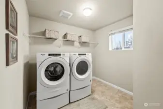 Convenient upstairs laundry room with plenty of storage