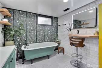 Lower full bath, AMAZING original clawfoot tub from the 1920's, refinished. I love all of this, the tile, the flooring, the makeup counter and LED mirrors!