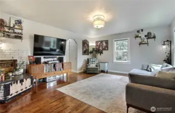 As you enter, you will find a large, lovely living room with gorgeous hardwood floors and light-inviting windows.