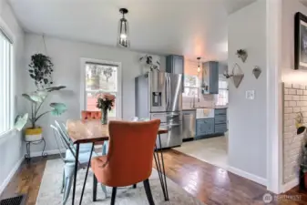 View of dining room & kitchen from living room, the large window to your left brings in so much light.