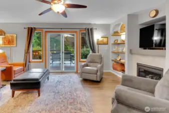 Living Area with Built In Shelving & Gas Fireplace, Leads to Outside Deck