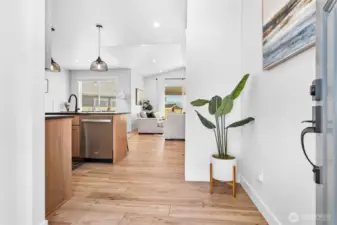 Inviting front entry, hall to left behind kitchen leads to 2nd & 3rd bdrms, full bath & large utility room